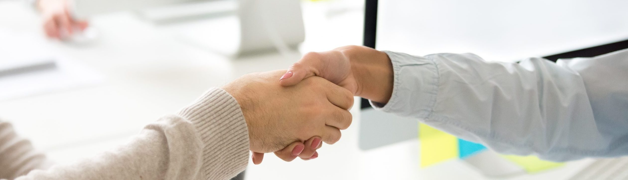 Handshake of man and woman after signing contract
