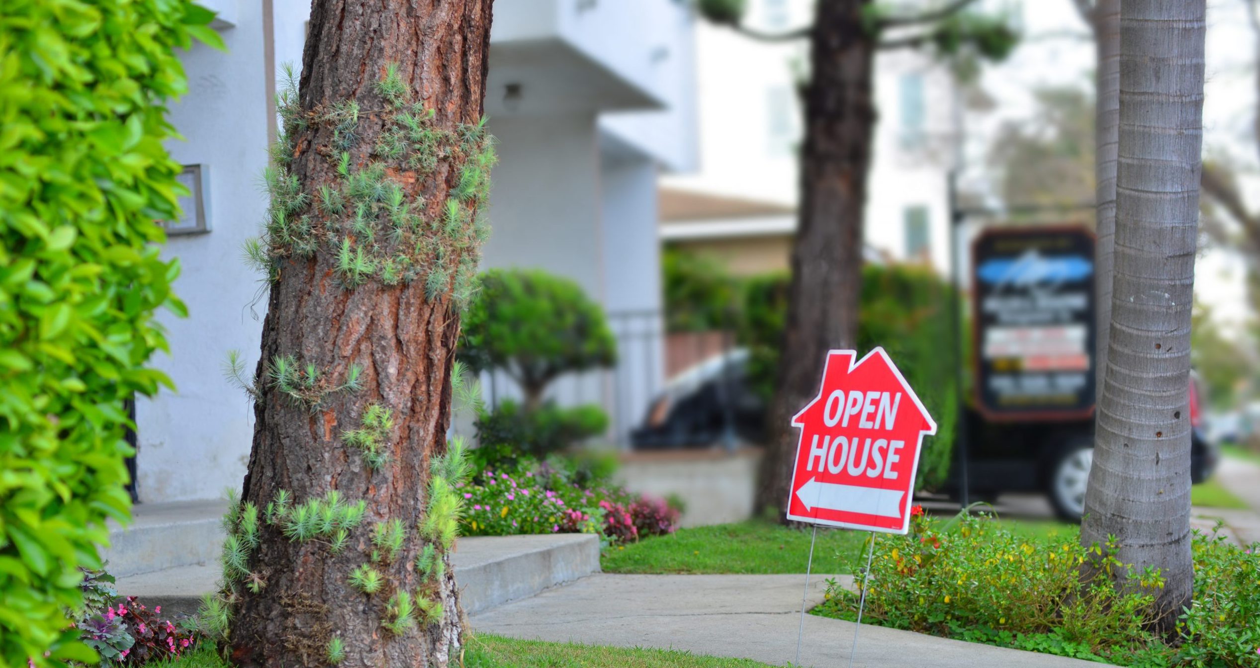 red open house sign in front of house