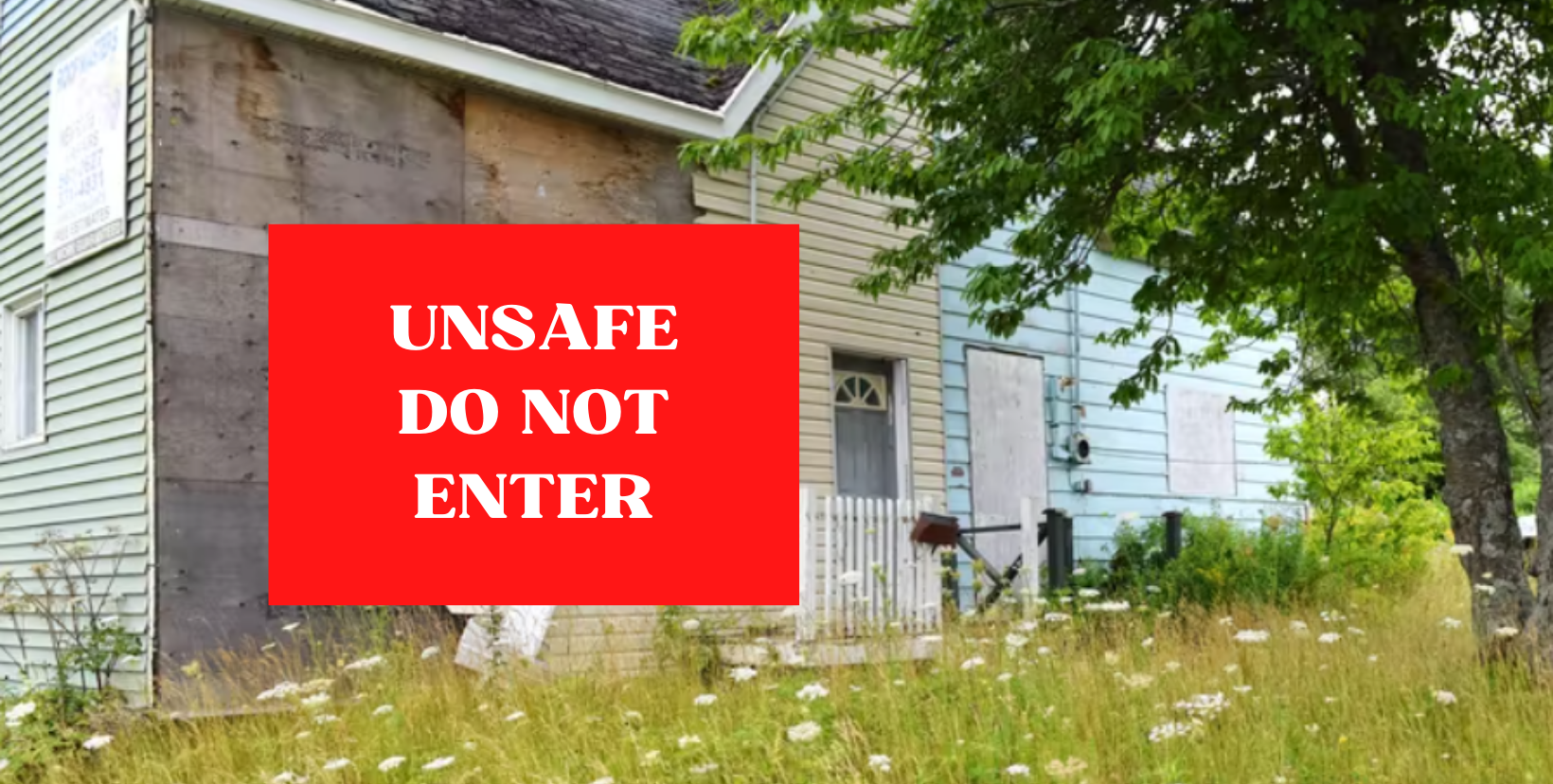 UNSAFE DO NOT ENTER sign in front of condemned house