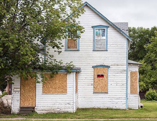 condemned house with boarded up windows